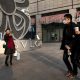 Pedestrians walk past a shopper taking a selfie; China's generation z;