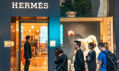 Shoppers wait in line outside a Hermes International store