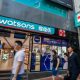 Pedestrians walk past a Watsons store