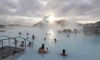 Tourists bathe in the Blue Lagoon geothermal spa as steam rises in Grindavik, Iceland.