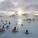 Tourists bathe in the Blue Lagoon geothermal spa as steam rises in Grindavik, Iceland.