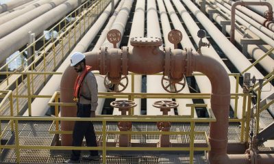 An employee inspects pipes used for landing and unloading crude and refined oil at the North Pier Terminal, operated by Saudi Aramco