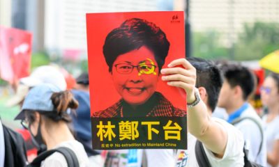 hong kong protester holding sign business news